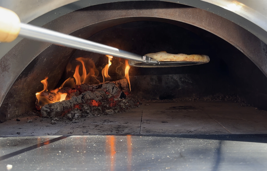 placing the pizza in the oven